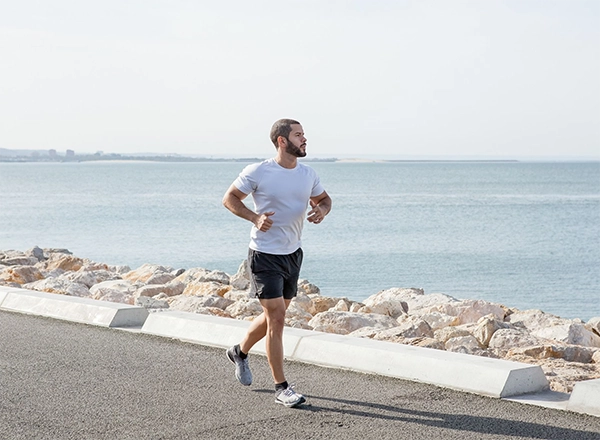 man jogging near the beach